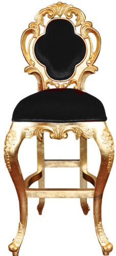 an ornate gold and black chair with a black cushion on it's backrest