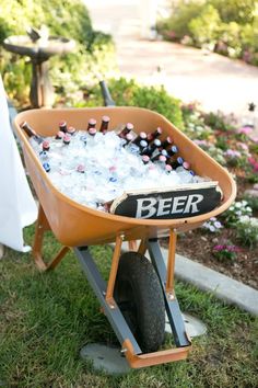 a wheelbarrow filled with bottles of beer