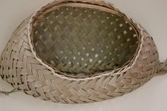 a large woven basket sitting on top of a white table