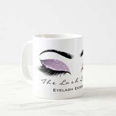 a white coffee mug with blue and black eyelashes on it, the words eyelash extension beauty studio