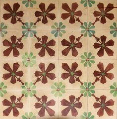 an old tile wall with many different designs on it's sides, including flowers and leaves