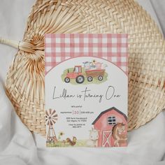 a pink and white checkered table cloth with a farm themed birthday card on it