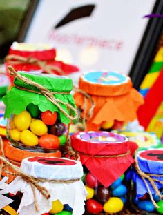 some jars filled with candy sitting on top of a table