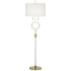 a white and gold floor lamp with a white shade on the top, an oval shaped light