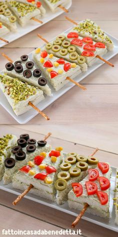 an assortment of appetizers are arranged on trays to be used as snacks