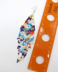 Amazing colors combined in a Modern Powwow Native American Style Seed Bead Earring set. Great new BOHO design with great colors and styling. Stainless steel ear wires and genuine high quality beads. A beautiful combination of colors and native design at a super price. All handmade. Shipped Free Multicolor Dangle Beads With Ear Wire, Multicolor Dangling Beads Drop Earrings, Adjustable Multicolor Beaded Earrings, Adjustable Multicolor Dangling Bead Earrings, Multicolor Dangling Beads For Crafting, Multicolor Chandelier Earrings With Round Beads, Multicolor Beaded Dangle Chandelier Earrings, Adjustable Multicolor Beaded Earrings With Ear Wire, Design Seed