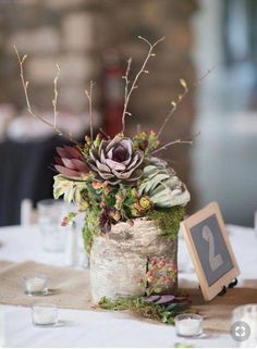 an arrangement of flowers in a vase on a table