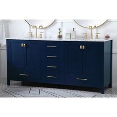 a bathroom vanity with two sinks and gold faucets on the top, against a white wall