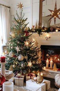 a decorated christmas tree in front of a fire place with candles and presents under it