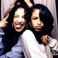 two women are posing for the camera with their hands on their hipss and one is holding her head