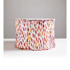 a white and red polka dot print ribbon on a table with a gray wall in the background