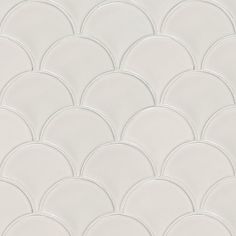 a close up view of the back side of a white tile wall with wavy circles