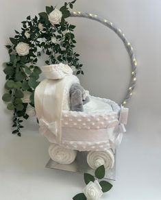 a teddy bear in a baby carriage with flowers and greenery around the edges, on a white background