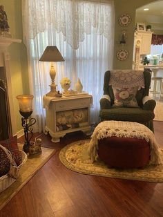 a living room filled with furniture and a fire place in front of a large window