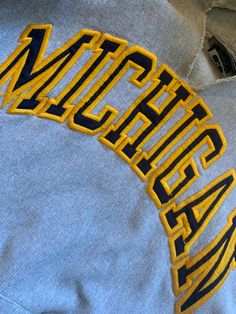 Vintage 90s Michigan Hoodie Sweatshirt  Size Medium See pics for measurements  Premium Quality Reverse Weave material  Quality brand Steve & Barrys  Thrashed   Collar torn to be more open  Cut Off Sleeves to 3/4 length  Waist torn to be more open  Minor spots on one sleeve as pointed out in pic  Quality Embroidered Michigan Logo Letters  Classic Gray with Navy Blue and Yellow Maize Colors  Alums - wear this to the farmers market on Saturday morning - or to your favorite coffee shop - ie relaxed Vintage Letter Embroidery Sweatshirt For Streetwear, Throwback Cotton Sweatshirt With Embroidered Logo, Throwback Cotton College Sweatshirt, Throwback Cotton Sweatshirt For College, Retro Cotton Hoodie Sweatshirt, Vintage Letter Embroidery Tops For Streetwear, Vintage College Sweatshirt With Embroidered Logo, Vintage Sweatshirt With Embroidered Logo For College, Vintage Embroidered Logo Sweatshirt For College