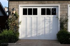 a white garage door with windows on the side