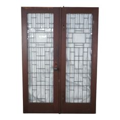 two brown doors with glass panels on each side