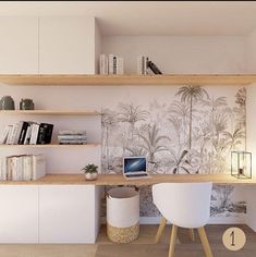 a desk with two chairs and a laptop on top of it in front of shelves