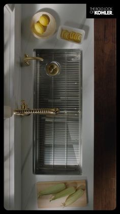 an overhead view of a shower with metal grates and yellow apples on the counter