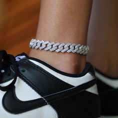 Introducing the Diamond Prong Cuban Anklet in White Gold- 12mm, a stand out piece. This exclusive anklet is iced out in hand-set stones and set in 14k White Gold- its the perfect drip for upgrading any shoe. Pair it with the Diamond Prong Cuban Necklace and Bracelet to complete the entire look! This product is guaranteed for life – GLD will repair or replace the item should you experience any defects in craftsmanship or breakage. Specifications - Width: 12mm - Length: 8-10" or 9"-11" Adjustable Cuban Anklet, Diamond Anklet, Cuban Necklace, Women Anklets, Necklace And Bracelet, Vermeil Jewelry, Custom Earrings, Women Diamond, A Stand