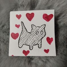 a piece of paper with a drawing of a dog on it and hearts around it