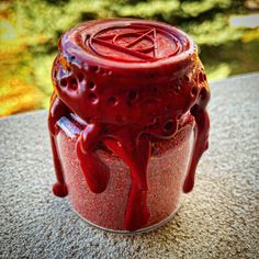 a red jar sitting on top of a table