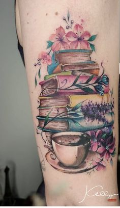 a woman's thigh with books and flowers on it