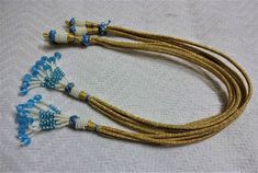 Bright and beautiful adjustable handmade necklace thread / necklace zari cord with blue beaded tassels. Looks good with big pendants or chokers can see in the picture. SIZE: 2 inches can go upto 20 inches ( 10 inches each side ). You will receive a set of six adjustable necklace thread / necklace cord. NECKLACE NOT INCLUDED. We do take wholesale orders. Traditional Handmade Adjustable Tassel Necklace, Traditional Beaded Necklace With Tassels, Traditional Blue Beaded Necklaces For Celebrations, Traditional Blue Beaded Necklace For Celebrations, Blue Tassel Necklace With Round Beads For Gift, Traditional Blue Beaded Necklace With Gold Beads, Necklace Thread, Thread Necklace, Necklace Cord