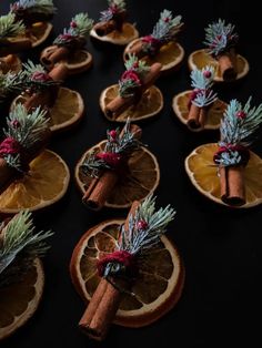 orange slices decorated with cinnamon sticks and pine cones are arranged in the shape of christmas decorations