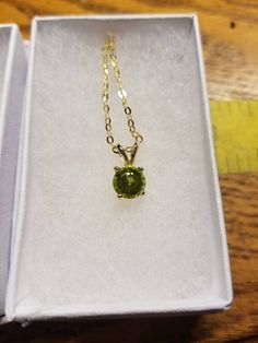 7 mm round peridot pendant set in 14 K mounting on 18 inch gold plated chain. approximately 1.25 carats. Gold Peridot Round Pendant Necklace, Gold Necklace With Round Peridot Pendant, Elegant Gold Peridot Birthstone Necklace, Round Cut Peridot Jewelry In Yellow Gold, Peridot Pendant, Gold Plated Chains, Pendant Set, Houston Tx, Houston