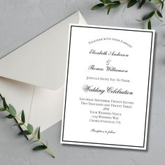 an elegant wedding card and envelope with greenery