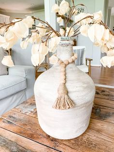 a vase with flowers in it sitting on a table