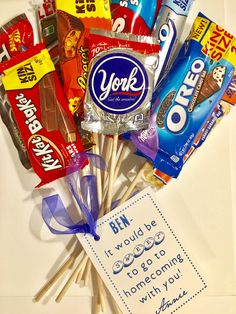 an assortment of candy on sticks with a thank you note