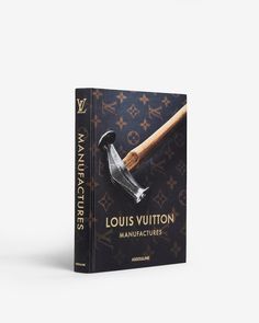 A book titled Louis Vuitton Manufactures features a cover with a hammer on a dark background, embellished with the Louis Vuitton monogram pattern. The text on the cover celebrates the brand's artisanal excellence from their ateliers. The spine and bottom include the publisher's name, Assouline. Louis Vuitton Artisan, Louis Vuitton Catwalk Book, Louis Vuitton Book, Geneva Switzerland, Texas Usa, British History, Inspirational People, Environmental Impact, High Jewelry