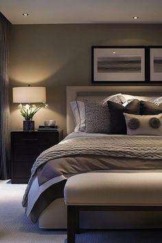 a large bed sitting next to two lamps on either side of it in a bedroom