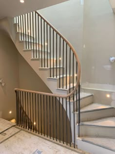 an image of a staircase in the middle of a room with white walls and black railings