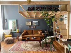 a living room filled with furniture and plants