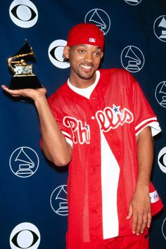 a baseball player holding an award in his hand