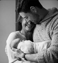 a man holding a baby in his arms