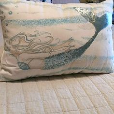 there is a pillow with a mermaid on it