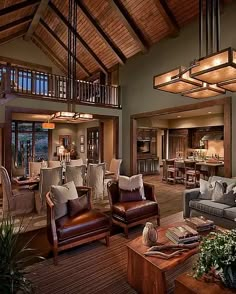 a living room filled with furniture and lots of windows in the ceiling above it is a large open floor plan