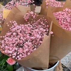 some pink flowers are sitting in a bucket