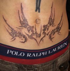 a woman's lower back tattoo with birds and stars on her stomach, which reads polo ralph lauren