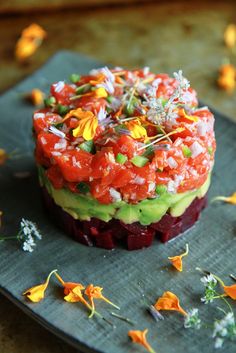 a plate topped with an avocado and tomato tart covered in toppings