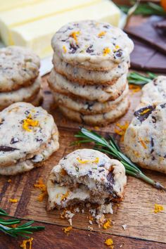 cookies with orange zest and chocolate chips on a cutting board next to some cheese