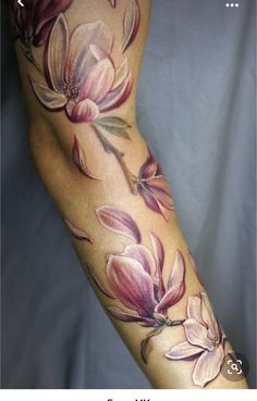 a woman's arm with flowers painted on it