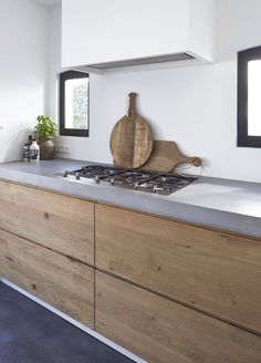 a modern kitchen with wooden cabinets and white walls