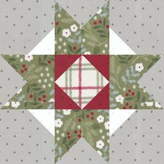 a quilted star with red and white designs on the center, surrounded by grey dots