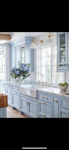 a large kitchen with blue cabinets and white counter tops is featured in this postcard