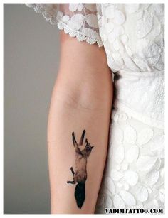 a woman's arm with a tattoo on it that has a hand holding an umbrella